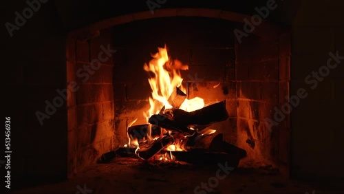 Burning Fire In The Fireplace. Wood And Embers In The Fireplace Detailed Fire Background. Warm Cozy Fireplace with Real Wood Burning in it. Cozy Winter Concept. Video for Meditation. Screen saver photo