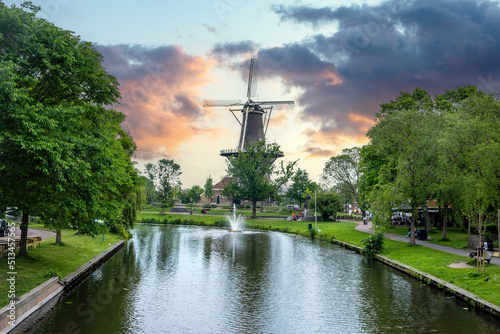 Windmill De Valk at sunset, tower mill and museum in Leiden city, Holland Netherlands. photo