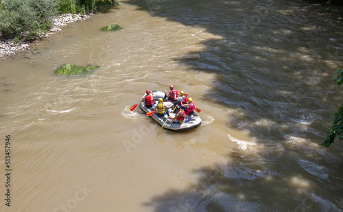 River rafting in Greece above view. People in safety gear on a raft, Vale of Tempi, Thessaly