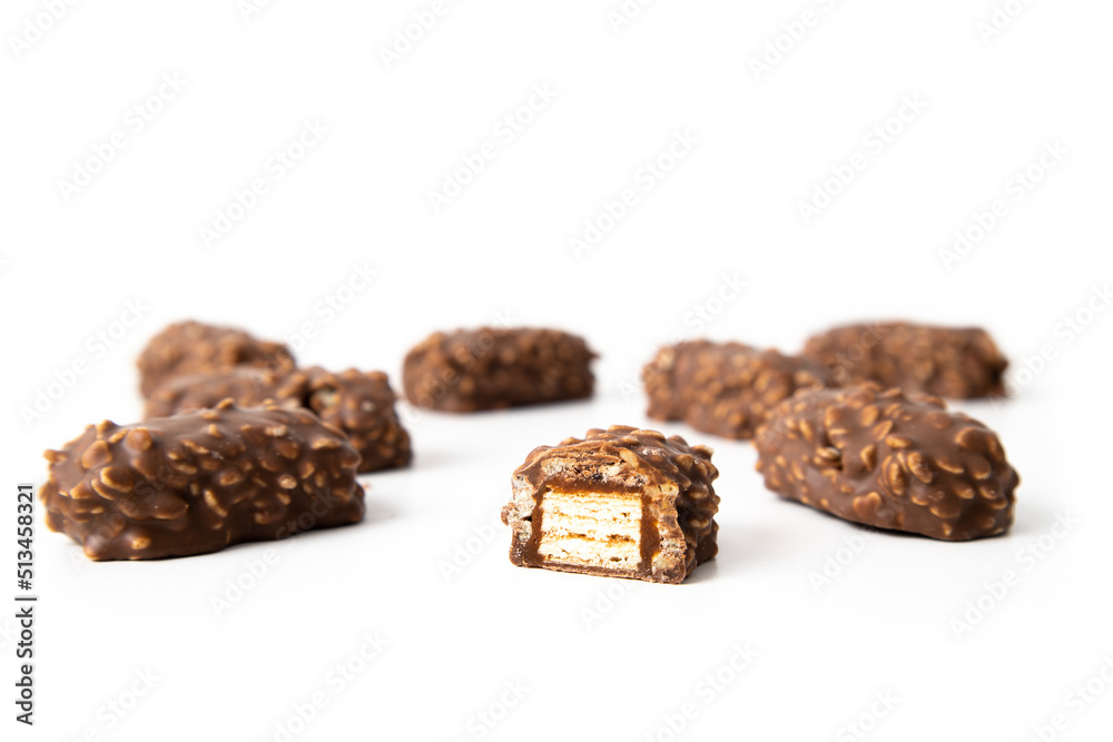 Chocolate candy bars wafers handmade lie on a white background Chocolate candy bars wafers handmade lie on a white background
