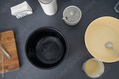 Dough in a bowl is kneaded on a kitchen surface. Top view baking dish, flat lay