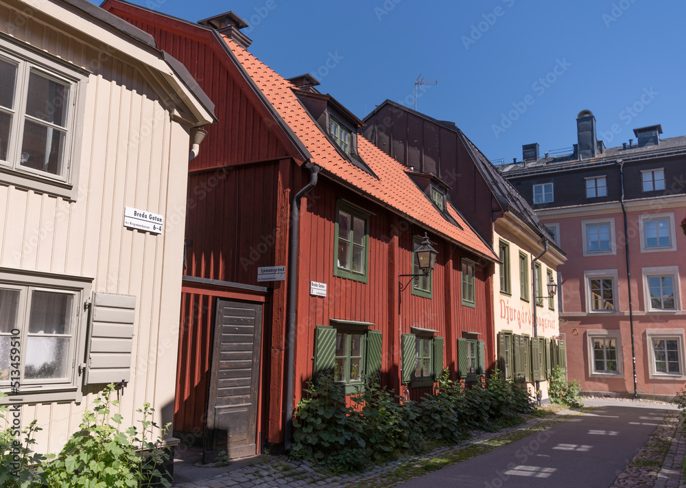 Old wood houses in the block Djurgårdsstaden at the street Långa Gatan in the island Djurgården a sunny summer day in Stockholm