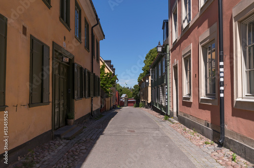 Old wood houses in the block Djurgårdsstaden at the street Långa Gatan in the island Djurgården a sunny summer day in Stockholm