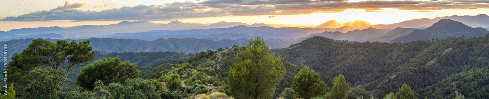 Beautiful mountain scenery with a vivid sunset in the cloudy sky, feeling of peace, serenity and freshness. Mountains of Malaga.