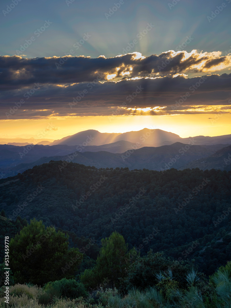 Obraz premium Beautiful mountain scenery with a vivid sunset in the cloudy sky, feeling of peace, serenity and freshness. Mountains of Malaga.