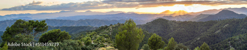 Beautiful mountain scenery with a vivid sunset in the cloudy sky, feeling of peace, serenity and freshness. Mountains of Malaga.