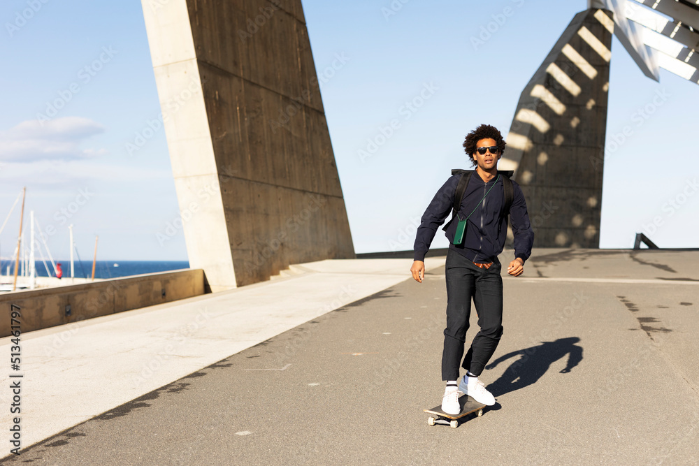 Handsome man with skateboard. Young smiling man having fun outdoors Handsome man with skateboard. Young smiling man having fun outdoors