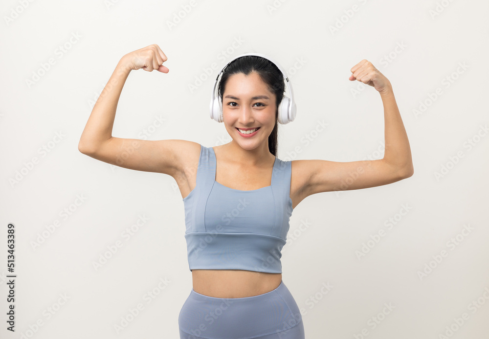 Sexy sporty fitness asian woman with sportswear put on headphone isolated white background. Portrait Good shape and healthy woman standing pose exercise workout in studio. Sexy sporty fitness asian woman with sportswear put on headphone isolated white background. Portrait Good shape and healthy woman standing pose exercise workout in studio.
