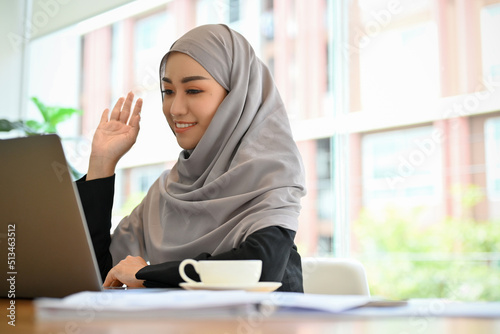 Beautiful muslim woman or businesswoman having an online meeting via laptop.