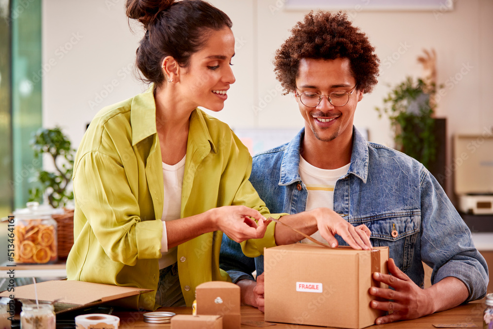 Couple Running Online Business From Home Packing And Labelling Boutique Candles Ready For Shipping Couple Running Online Business From Home Packing And Labelling Boutique Candles Ready For Shipping
