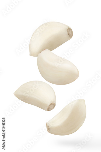 Flying delicious garlic cloves, isolated on white background