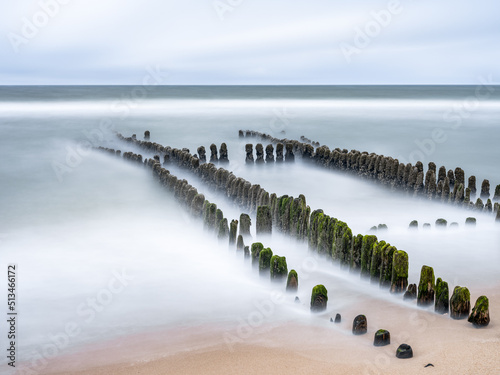 Wooden groyne at the North Sea coast near Rantum, Sylt, Schleswig-Holstein, Germany photo