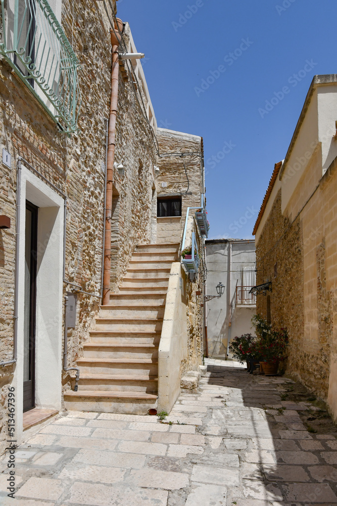 A narrow street among the old houses of Irsina in Basilicata, region of southern Italy.