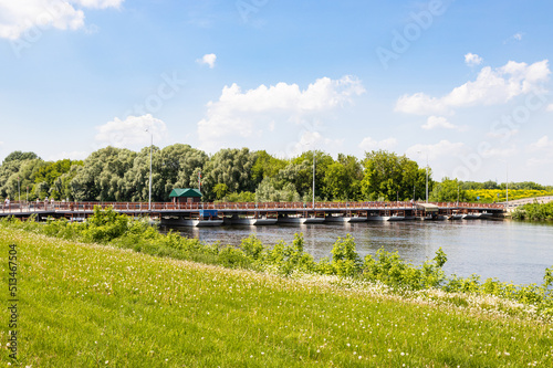 view of Bobrenevskiy pedestrian movable pontoon bridge on Moskva River in Kolomna city on sunny summer day