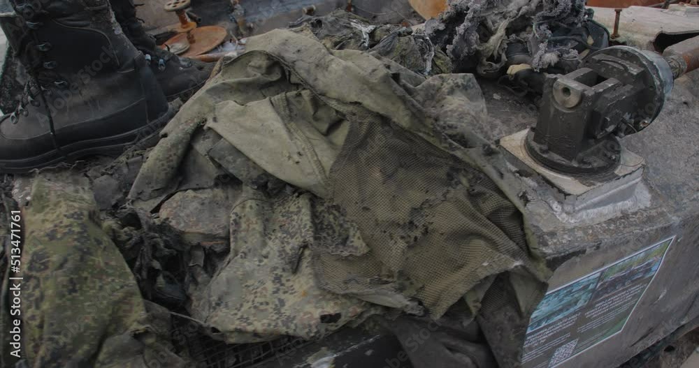 Close-up detailed tracking shot of the armor of a burnt-out Russian airborne combat vehicle. Exibition in Kyiv on Sophia Square The uniform of the killed soldier destroyed by the explosion Close-up detailed tracking shot of the armor of a burnt-out Russian airborne combat vehicle. Exibition in Kyiv on Sophia Square The uniform of the killed soldier destroyed by the explosion