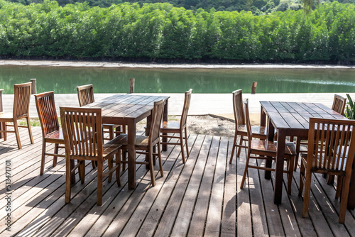 Dining table on the wooden bridge by the water 