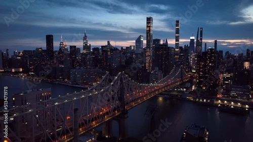 dusk flying alongside Ed Koch Queensboro Bridge toward NYC skyline photo