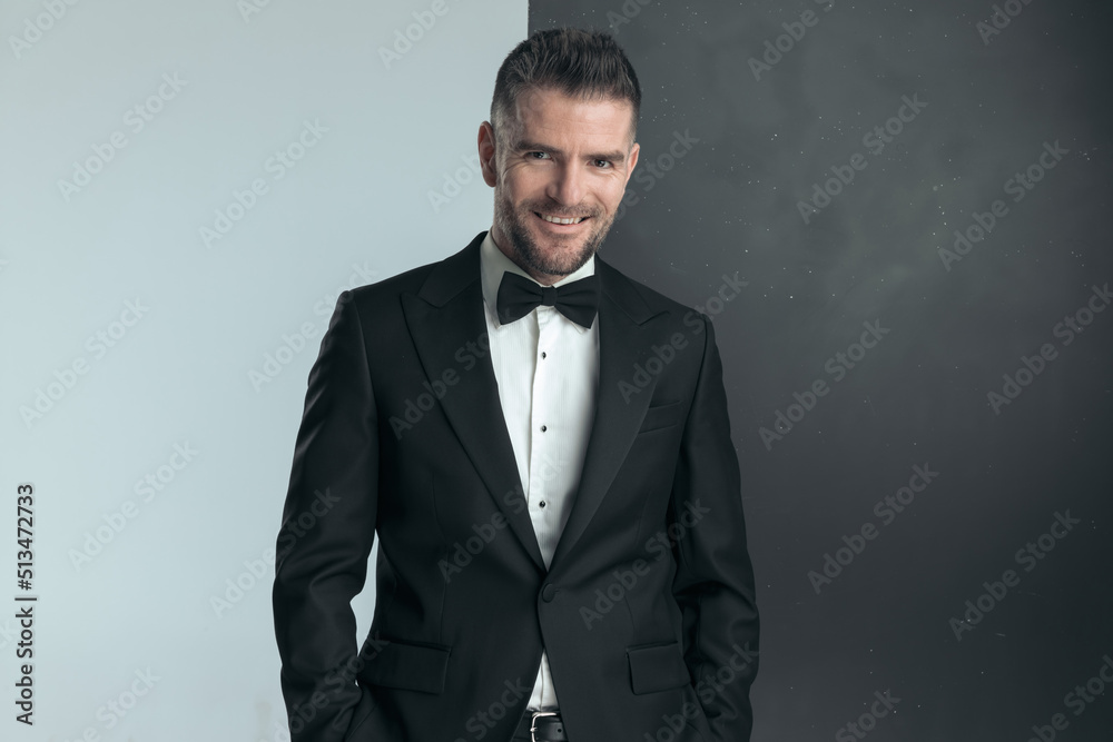 elegant businessman in tuxedo is smiling at the camera elegant businessman in tuxedo is smiling at the camera