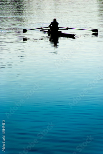 silhouette of a woman training with canoe in the river