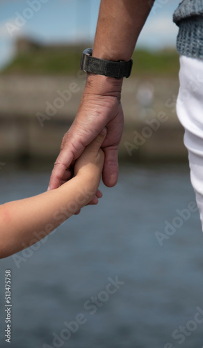 mother holding hand of small child