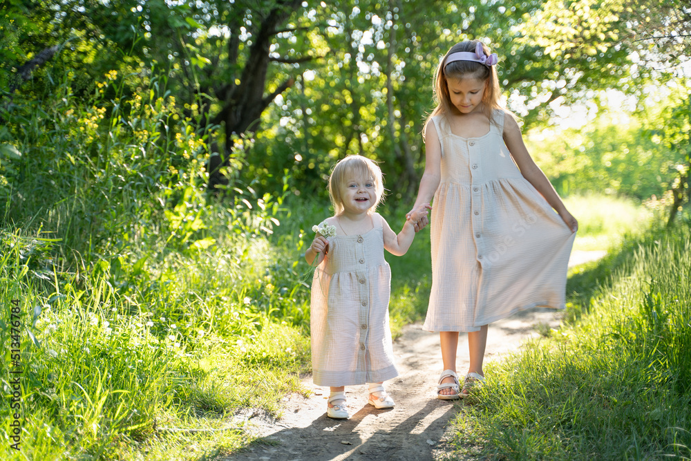 Fototapeta premium two girls are walking in the park
