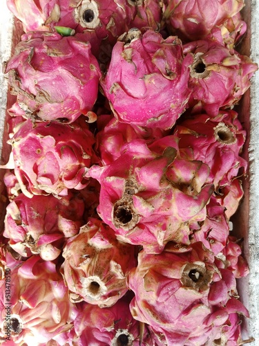 pile of ripe red-pink dragon fruit. fruit that is suitable for a healthy diet menu