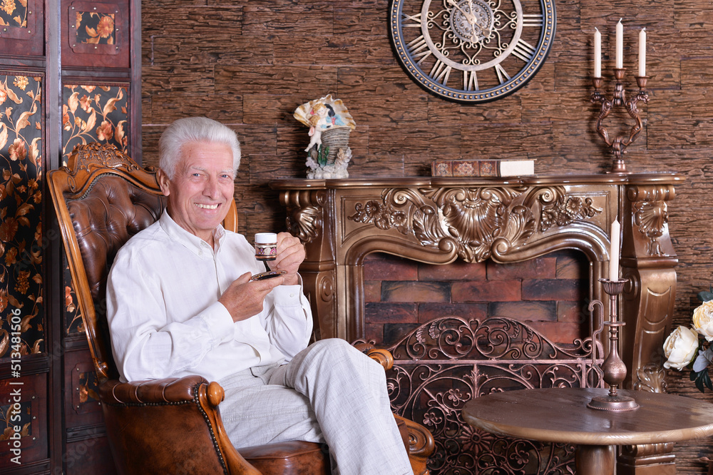 smiling senior man drinking coffee smiling senior man drinking coffee
