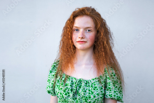 Close up freckled curly girl smiling. Natural beauty young cheerful redheared woman photo