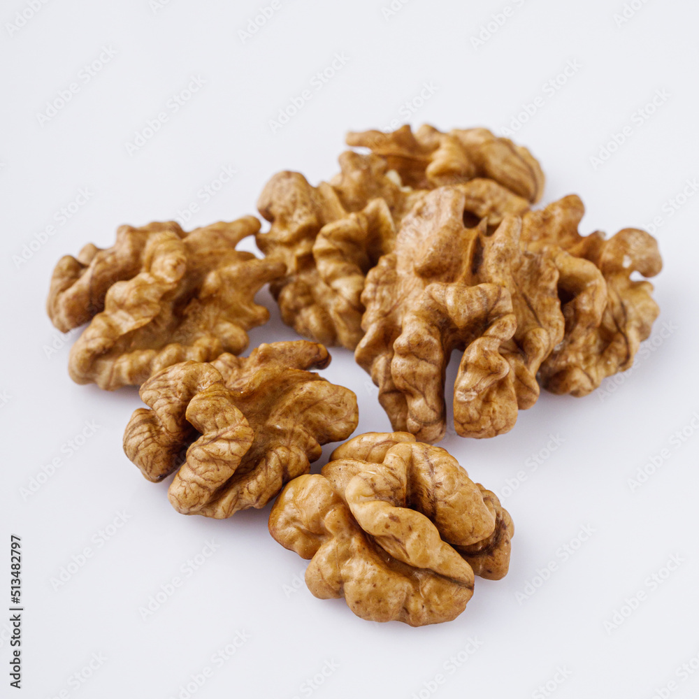 dried walnuts on a white acrylic background dried walnuts on a white acrylic background
