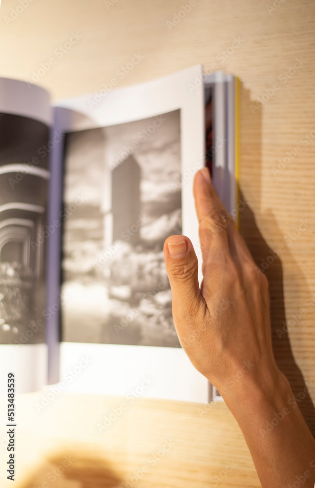 The image of the hand of a person holding a book and reading to learn. The image of the hand of a person holding a book and reading to learn.