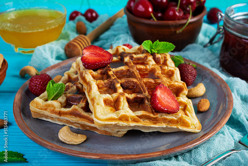 Delicious breakfast with belgian waffles. Waffels with strawberry and berry jam