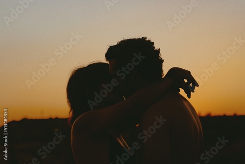 silhouette of couple kissing