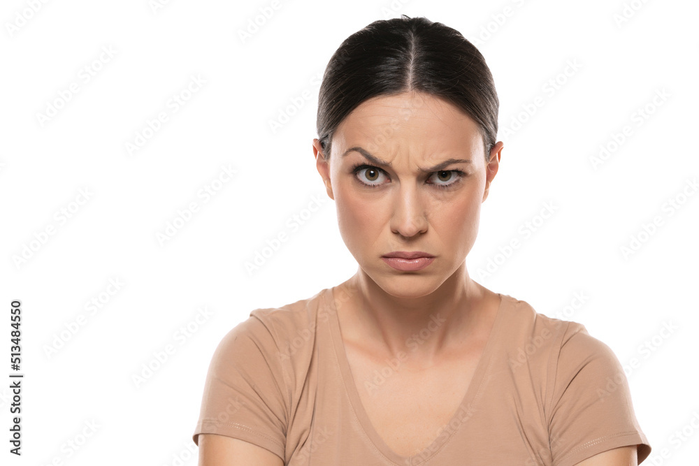Portrait of angry young woman over white background Portrait of angry young woman over white background