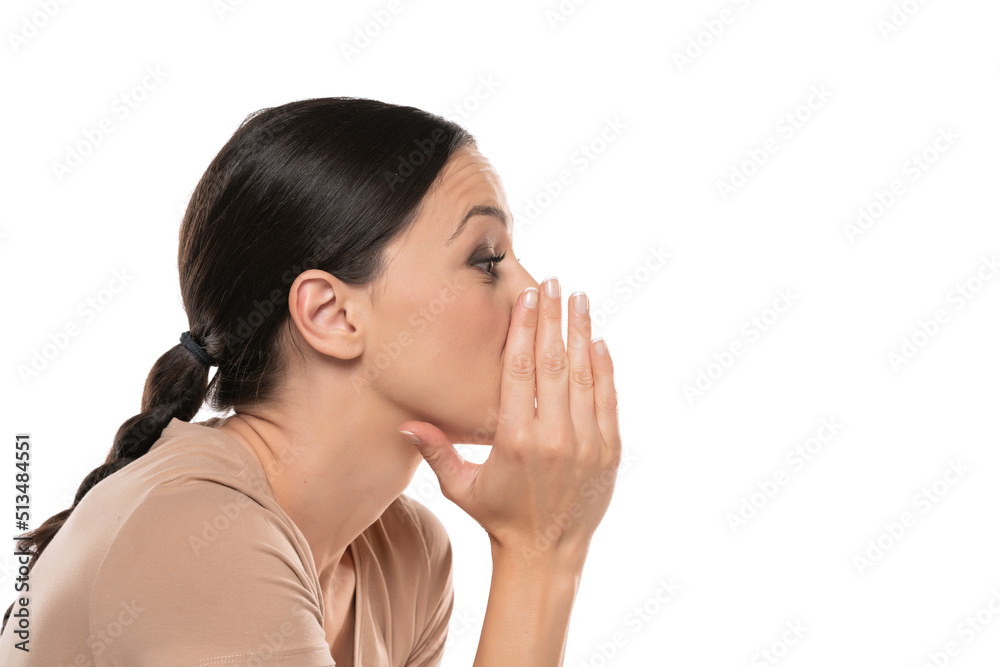 Profile image of whispering young lady , posing isolated over white background Profile image of whispering young lady , posing isolated over white background