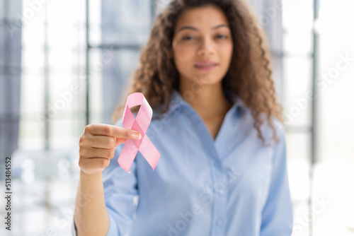 October breast cancer awareness month, woman with hand holding pink ribbon for supporting people living and illness. Healthcare, world cancer day concept.