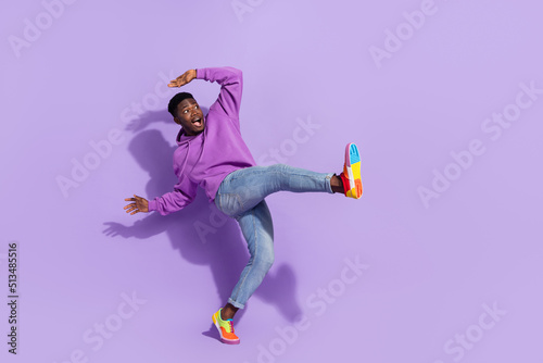 Full length portrait of cheerful satisfied person enjoy free time discotheque isolated on violet color background