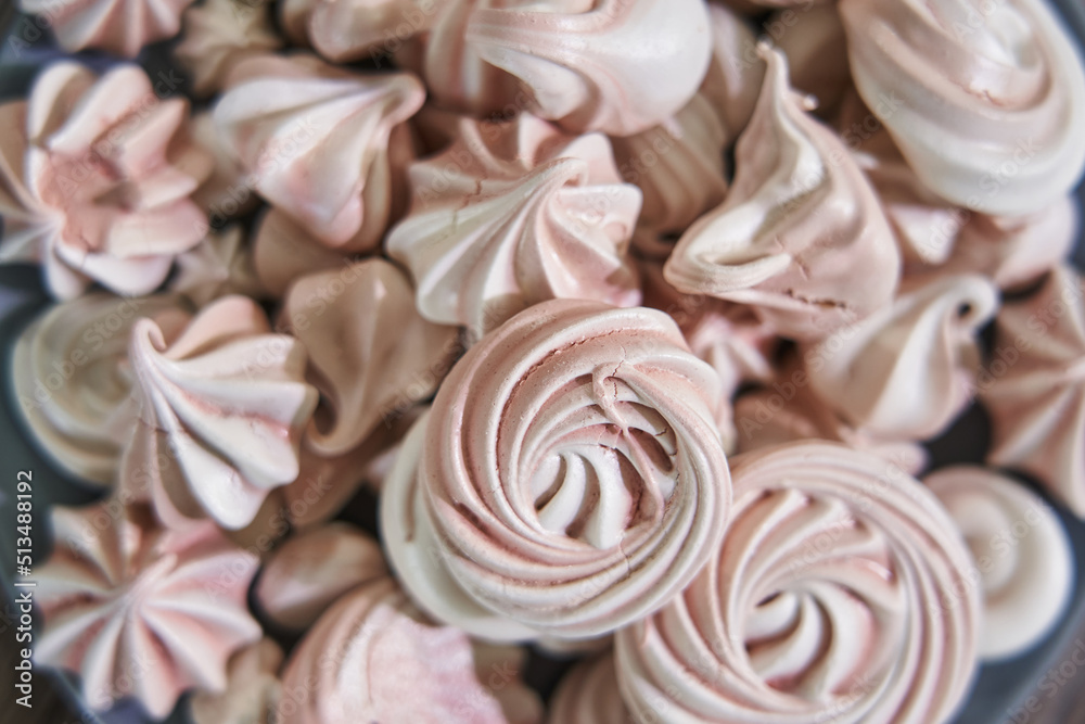 pink meringues on a plate close-up, different sizes, top view pink meringues on a plate close-up, different sizes, top view