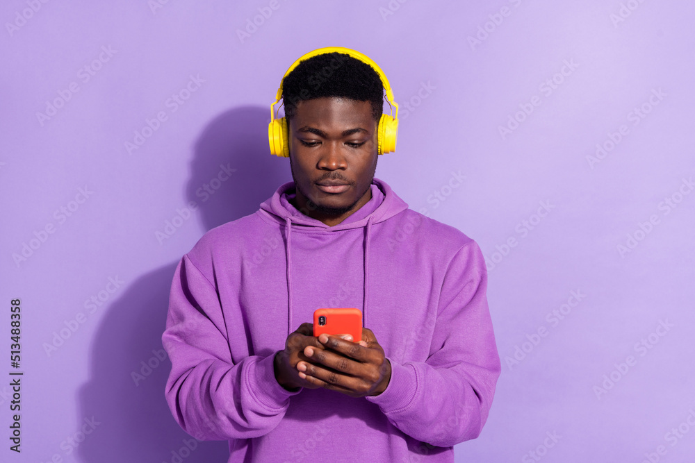 Photo of calm serious person hold use telephone chatting social network isolated on purple color background Photo of calm serious person hold use telephone chatting social network isolated on purple color background