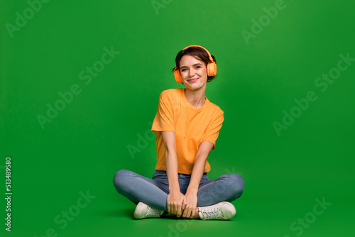 canvas print motiv - deagreez : Full length photo of charming peaceful girl sit floor enjoy new playlist isolated on green color background