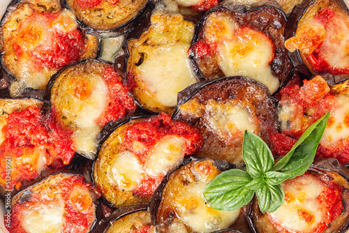 Tableau sur toile Close up of homemade baked eggplant Parmigiana di melanzane, made with mozzarella, tomato and basil leaves
