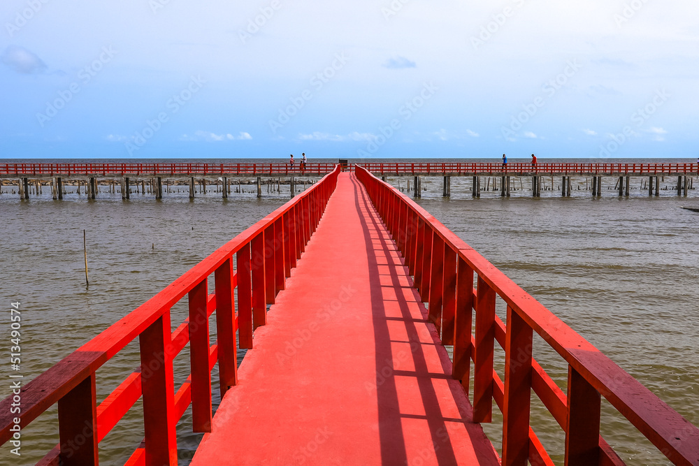 Red Boardwalk Bridge near Matchanu Shrine,Phanthai Norasing,Samut Sakhon,Thailand.
