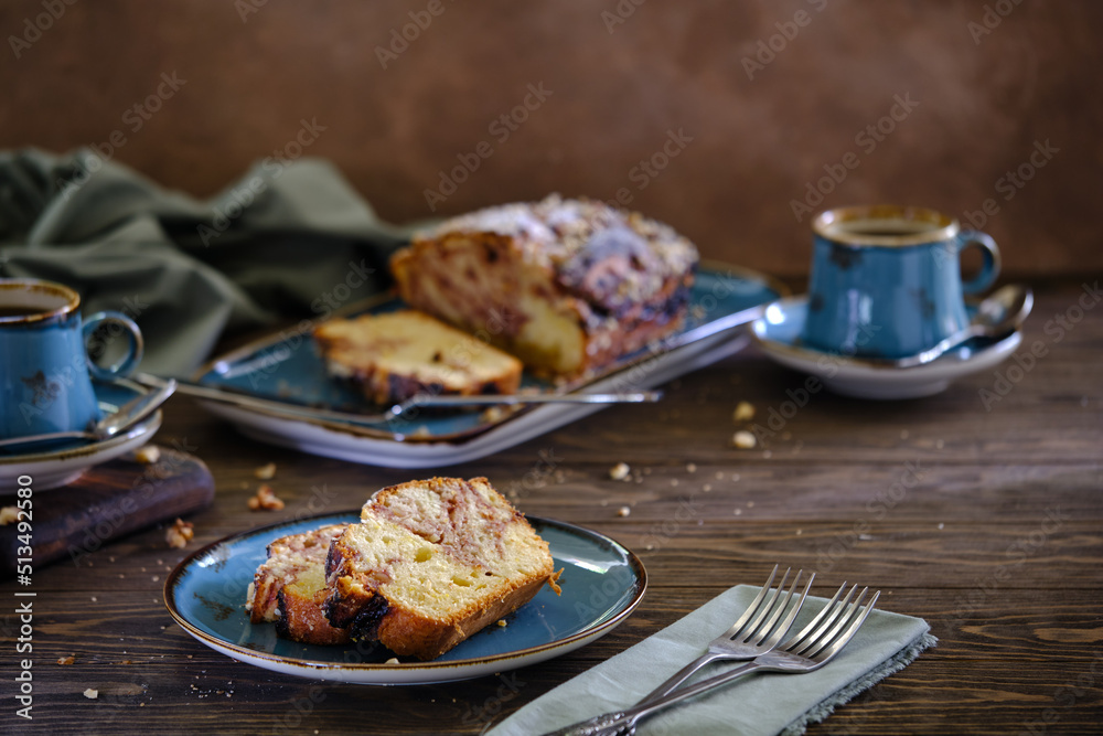 Home pound cake with lemon and strawberry filling on a blue plate on a wooden table. Home pound cake with lemon and strawberry filling on a blue plate on a wooden table.