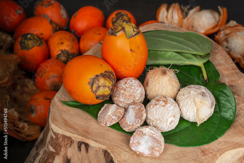 Betel nut or areca nut with betel leaf isolated on wooden background.