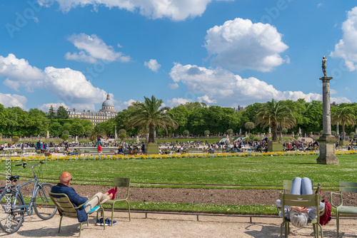 Paris, France - April 24, 2022: The Jardin du Luxembourg on a warm spring day. People relaxing in the garden.