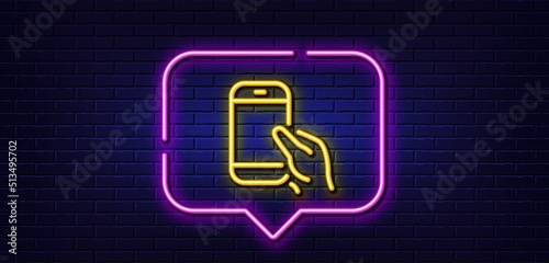 Neon light speech bubble. Hold Smartphone icon. Give Cellphone or Phone sign. Ð¡ommunication Mobile device symbol. Neon light background. Hold Smartphone glow line. Brick wall banner. Vector