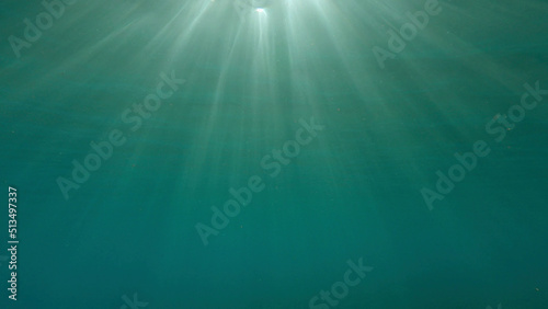 Sunrays penetrate through the surface of the water. Underwater light creates a beautiful veil, consisting of sunlight. range rays of the sun at sunset under the surface of the water. Red sea, Egypt