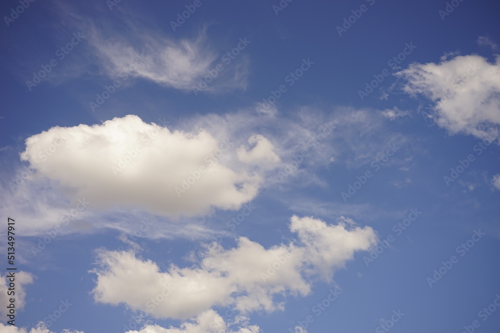 Summer background lovely blue sky with white fluffy clouds Summer background lovely blue sky with white fluffy clouds