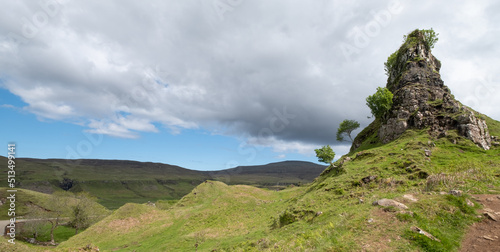 Fototapeta Naklejka Na Ścianę i Meble -  Fairy Glen on the Trotternish Peninsula, Uig Isle of Skye, Scotland UK. Varied landscape with small grassy hills, valleys and water ponds in the north of Skye.