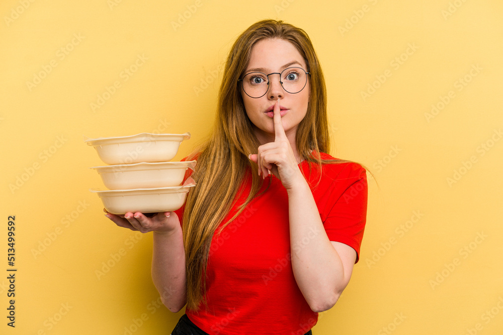 Young caucasian woman holding tupper isolated on yellow background keeping a secret or asking for silence. Young caucasian woman holding tupper isolated on yellow background keeping a secret or asking for silence.