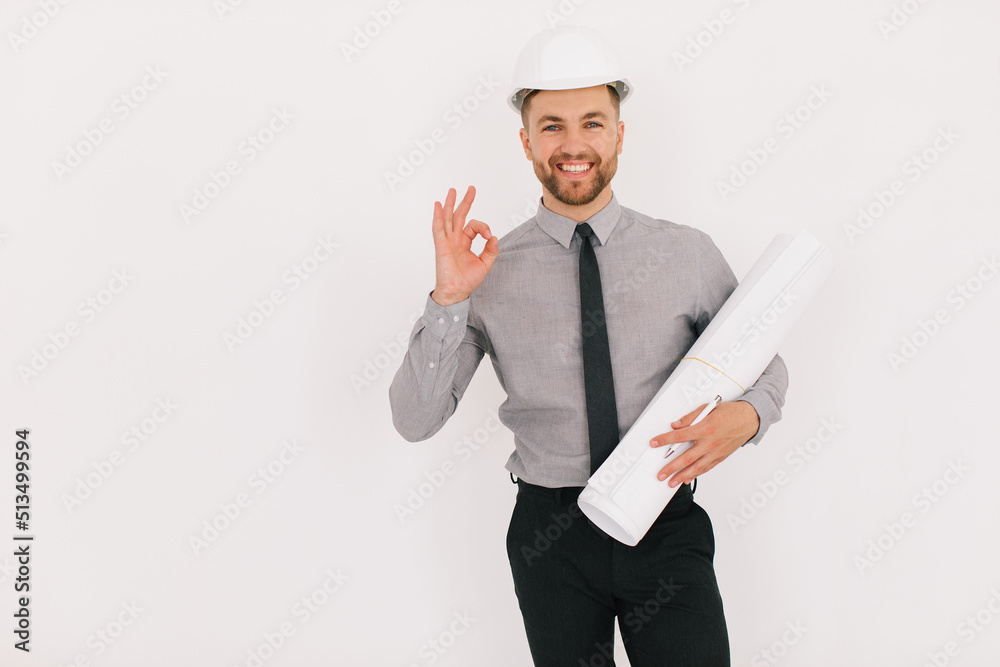 Happy male chief architect holding drawing with copy space on a white background Happy male chief architect holding drawing with copy space on a white background